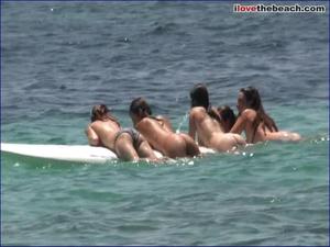 Peeping on naked girls playing in the waves