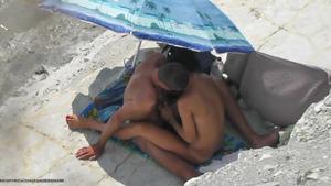 Couple cuddling on the beach