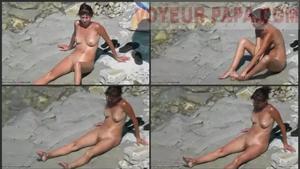 Sexy lady examined at a nudist beach