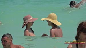 Lesbian nudist girls touch each other on the beach