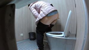 Hidden cam caught skinny girl climb on toilet to pee