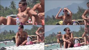 Topless teen enjoys music on beach