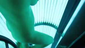 Spying on naked woman in tanning machine