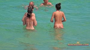 Peeping on naked girls playing in the waves