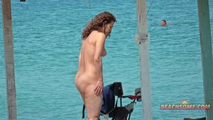 Naked ginger girl at a beach