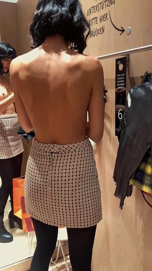 Peeping on geeky girl with lovely tits inside fitting room