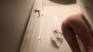 Spying on petite girl with awesome tan lines in bathroom