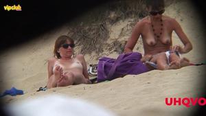 Hot woman sunbathing on a beach
